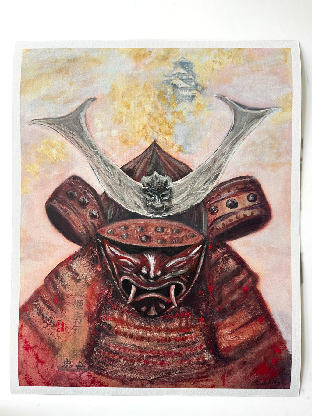 A Japanese-style art print depicting a samurai warrior in detailed red and copper armor with a horned helmet, set against a soft pink and gold background.
